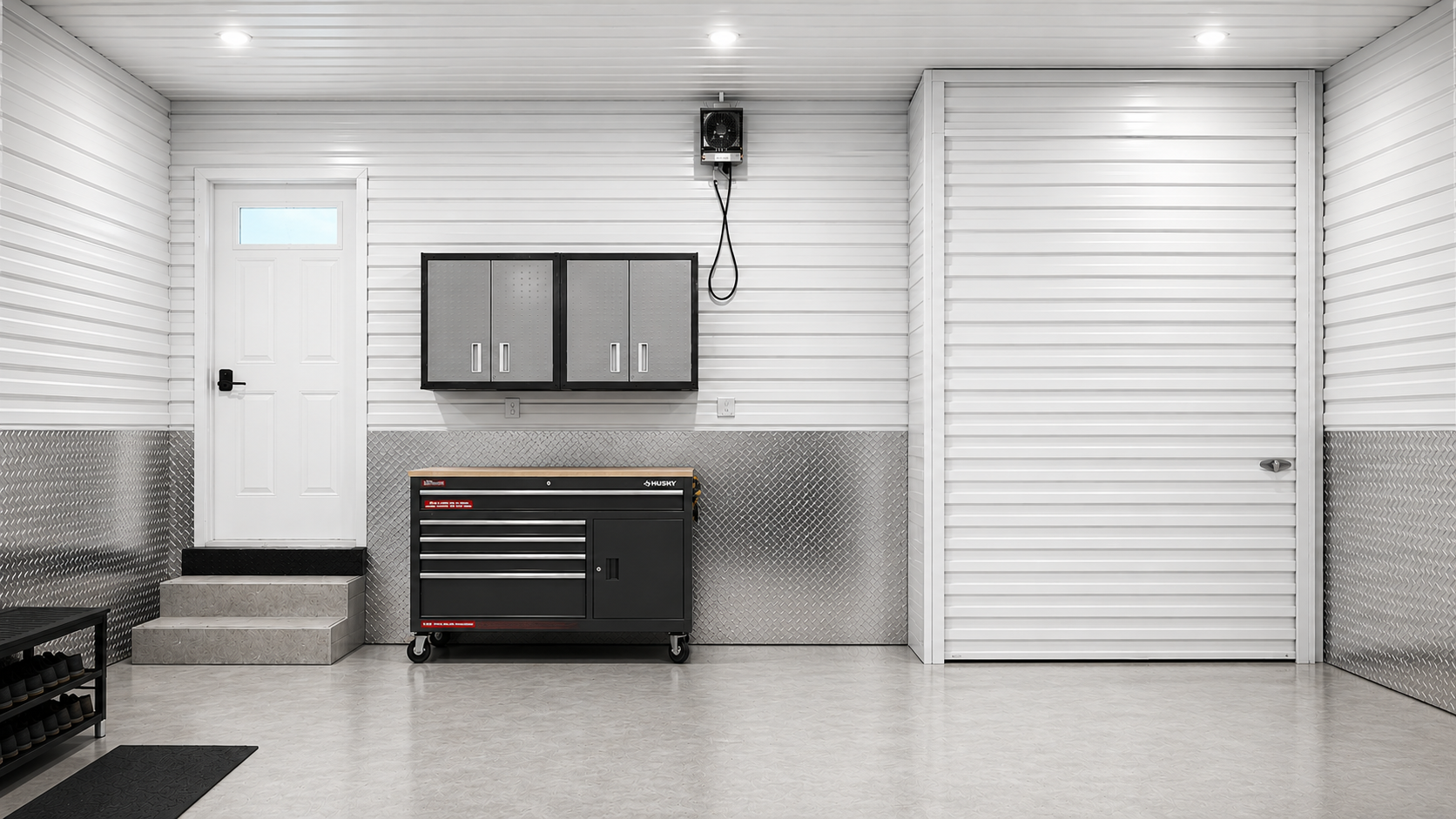 Garage wall with clutter concealed behind a flush white LuminaVault roll-up door